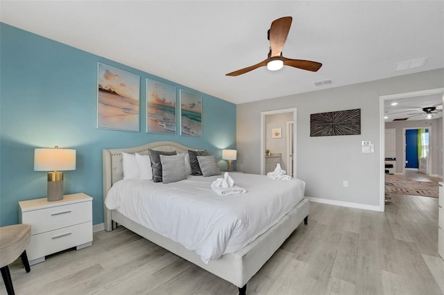 720 Gardenia Ln, Davenport, FL 33897 - bedroom with light wood-style flooring, a ceiling fan, and connected bathroom