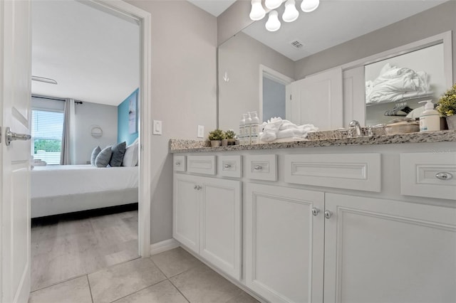720 Gardenia Ln, Davenport, FL 33897 - bathroom featuring ensuite bathroom, vanity, and tile patterned flooring