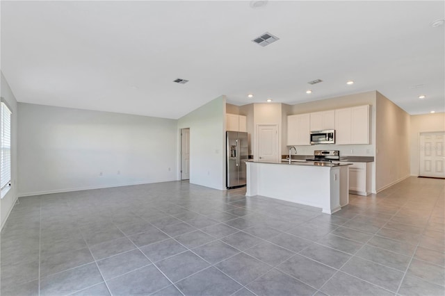 865 Citrus Reserve Blvd, Davenport, FL 33837 - kitchen with stainless steel appliances, open floor plan, light tile patterned flooring, a kitchen island with sink, and recessed lighting