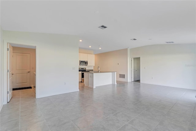 865 Citrus Reserve Blvd, Davenport, FL 33837 - unfurnished living room with recessed lighting, vaulted ceiling, and light tile patterned flooring