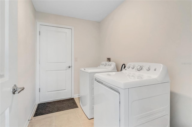 865 Citrus Reserve Blvd, Davenport, FL 33837 - laundry room featuring washing machine and dryer, baseboards, and light tile patterned floors