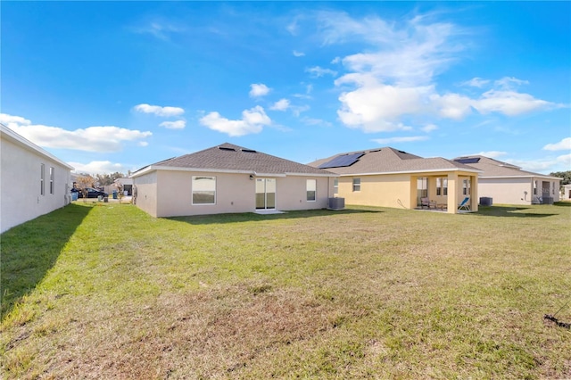 865 Citrus Reserve Blvd, Davenport, FL 33837 - back of property with a lawn, a patio area, central AC, and stucco siding