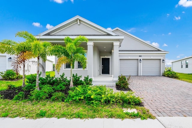 1596 Contentment Loop, Kissimmee, FL 34744 - view of front of home with decorative driveway, an attached garage, and stucco siding