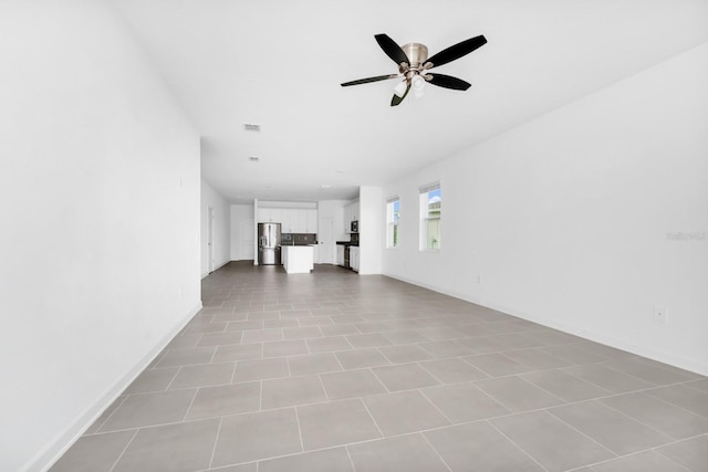 1596 Contentment Loop, Kissimmee, FL 34744 - unfurnished living room with a ceiling fan and baseboards