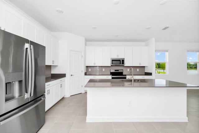 1596 Contentment Loop, Kissimmee, FL 34744 - kitchen featuring stainless steel appliances, a sink, light tile patterned flooring, and white cabinets
