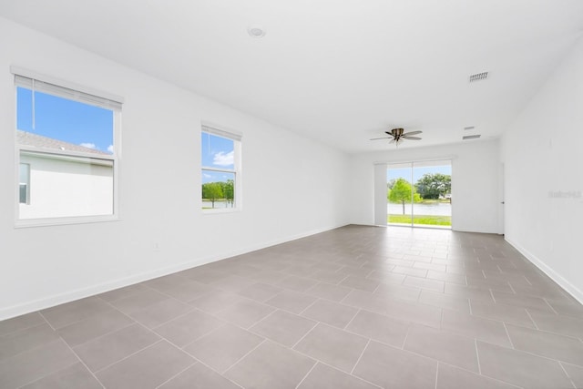 1596 Contentment Loop, Kissimmee, FL 34744 - spare room featuring ceiling fan and baseboards