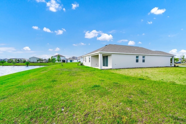 1596 Contentment Loop, Kissimmee, FL 34744 - rear view of house featuring a water view, a yard, and stucco siding