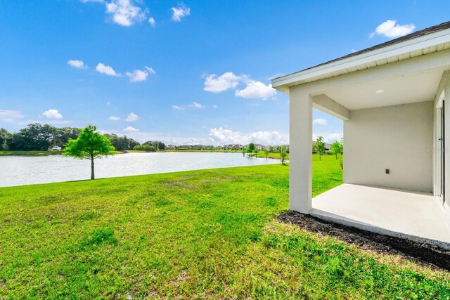 1596 Contentment Loop, Kissimmee, FL 34744 - view of grassy yard featuring a water view and a patio