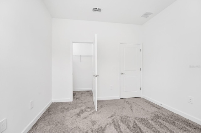 1596 Contentment Loop, Kissimmee, FL 34744 - unfurnished bedroom with carpet flooring, baseboards, a spacious closet, and a closet