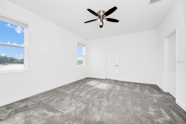 1596 Contentment Loop, Kissimmee, FL 34744 - unfurnished bedroom with carpet floors, baseboards, and a ceiling fan
