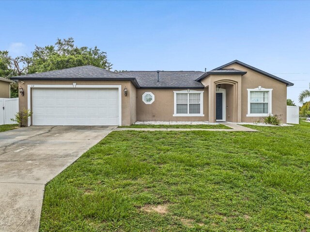 112 Lake Butler Ave, Haines City, FL 33844 - single story home with stucco siding, concrete driveway, an attached garage, and a shingled roof