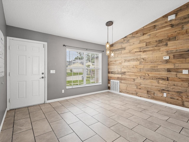 112 Lake Butler Ave, Haines City, FL 33844 - unfurnished dining area featuring wood walls, vaulted ceiling, a textured ceiling, and baseboards