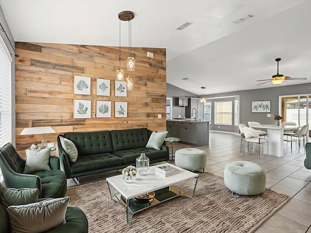 112 Lake Butler Ave, Haines City, FL 33844 - living area featuring lofted ceiling, light tile patterned flooring, a ceiling fan, and wooden walls