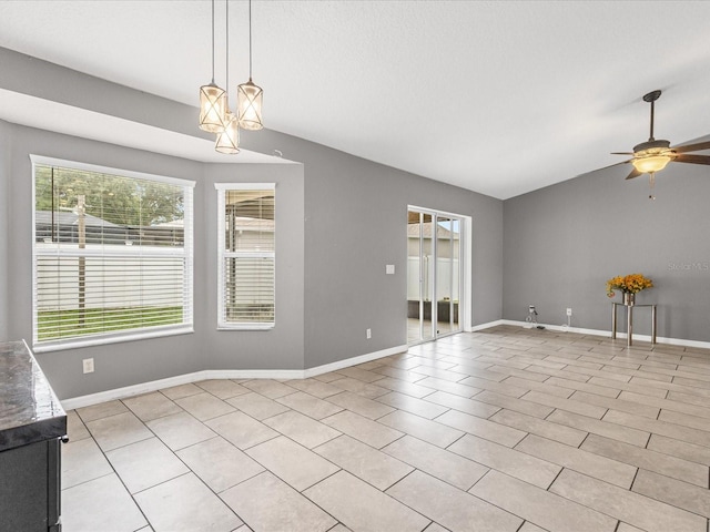 112 Lake Butler Ave, Haines City, FL 33844 - unfurnished living room featuring ceiling fan, baseboards, lofted ceiling, and light tile patterned floors