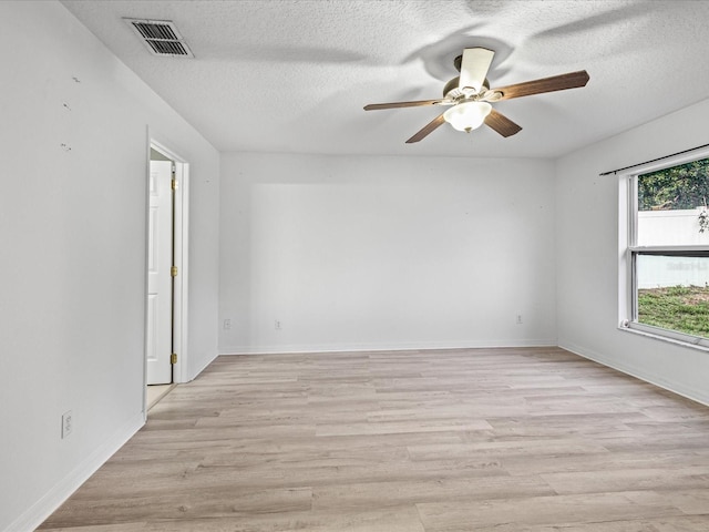 112 Lake Butler Ave, Haines City, FL 33844 - empty room with a ceiling fan, light wood finished floors, a textured ceiling, and baseboards