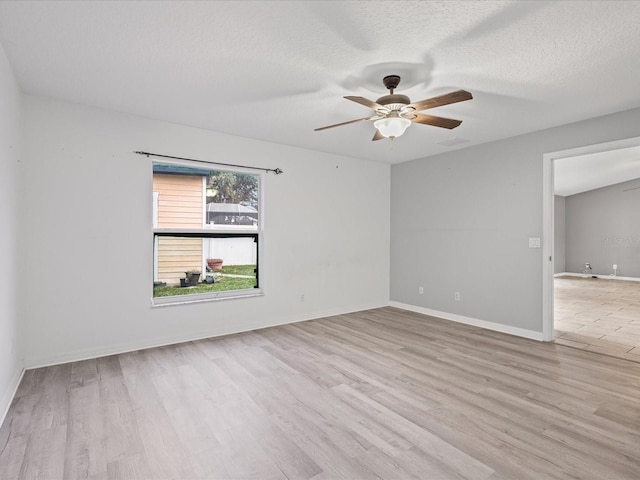 112 Lake Butler Ave, Haines City, FL 33844 - unfurnished room with a ceiling fan, wood finished floors, baseboards, and a textured ceiling