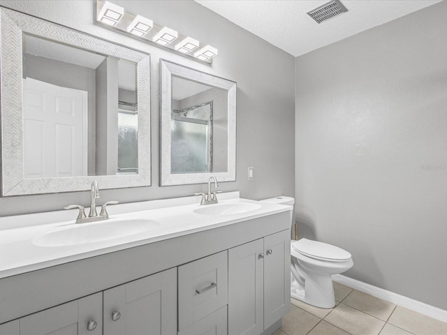 112 Lake Butler Ave, Haines City, FL 33844 - full bathroom with double vanity, toilet, tile patterned flooring, baseboards, and a shower