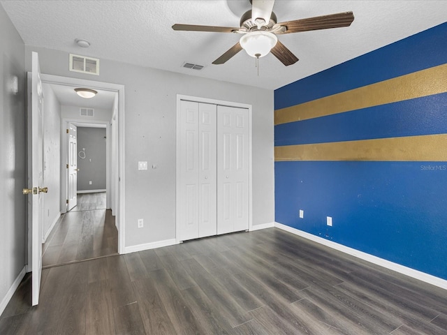 112 Lake Butler Ave, Haines City, FL 33844 - unfurnished bedroom with wood finished floors, baseboards, a textured ceiling, a closet, and a ceiling fan