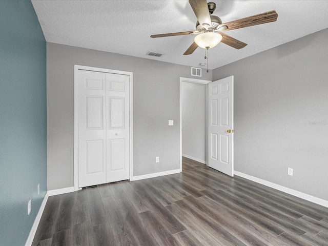 112 Lake Butler Ave, Haines City, FL 33844 - unfurnished bedroom featuring dark wood-style flooring, a closet, baseboards, and a textured ceiling