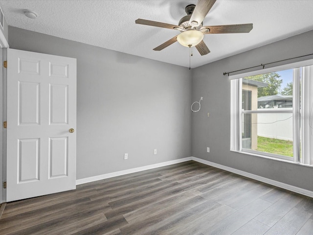 112 Lake Butler Ave, Haines City, FL 33844 - spare room with dark wood-type flooring, ceiling fan, baseboards, a smoke detector, and a textured ceiling