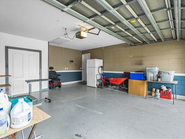 112 Lake Butler Ave, Haines City, FL 33844 - garage with freestanding refrigerator, a garage door opener, and concrete block wall