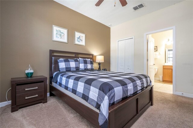 1439 Moon Valley Dr, Davenport, FL 33896 - bedroom featuring light carpet, a closet, ensuite bath, baseboards, and ceiling fan