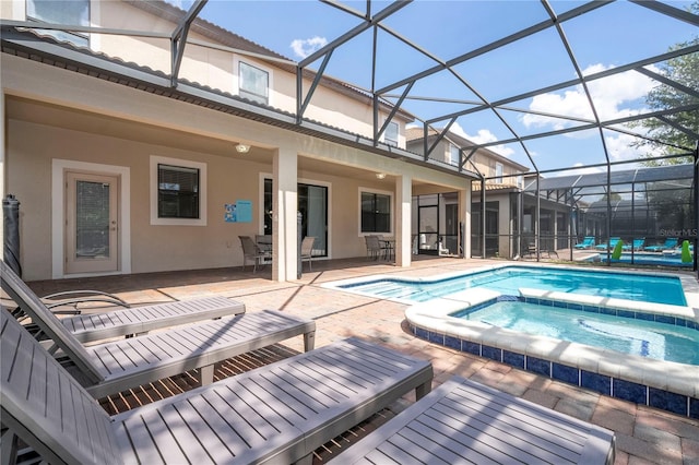 1439 Moon Valley Dr, Davenport, FL 33896 - view of pool with a patio area, a pool with connected hot tub, and glass enclosure