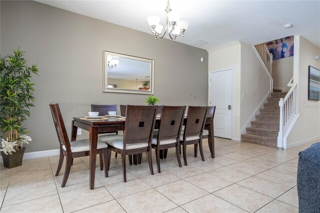 1439 Moon Valley Dr, Davenport, FL 33896 - dining room with stairway, a chandelier, light tile patterned floors, and baseboards