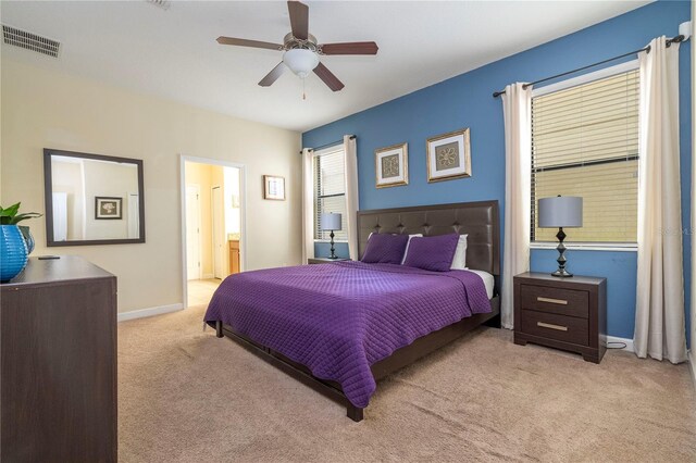 1439 Moon Valley Dr, Davenport, FL 33896 - carpeted bedroom featuring baseboards, ceiling fan, and connected bathroom