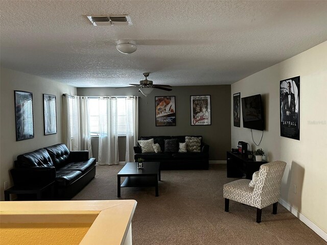 1439 Moon Valley Dr, Davenport, FL 33896 - living area featuring a textured ceiling, carpet flooring, ceiling fan, and baseboards