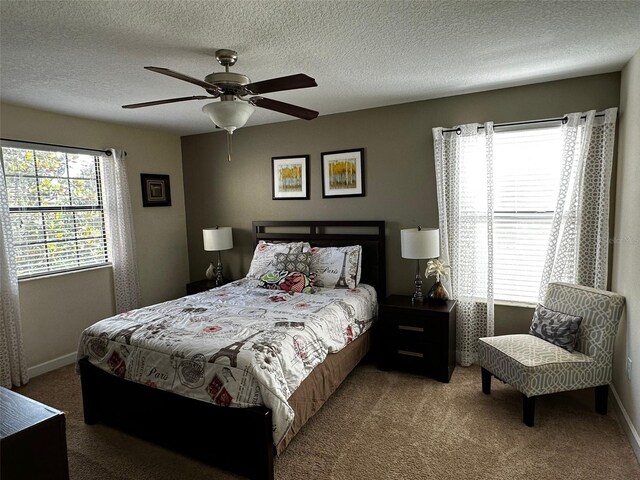 1439 Moon Valley Dr, Davenport, FL 33896 - carpeted bedroom with baseboards, ceiling fan, and a textured ceiling