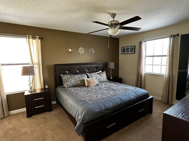 1439 Moon Valley Dr, Davenport, FL 33896 - bedroom featuring carpet floors, a ceiling fan, baseboards, and a textured ceiling