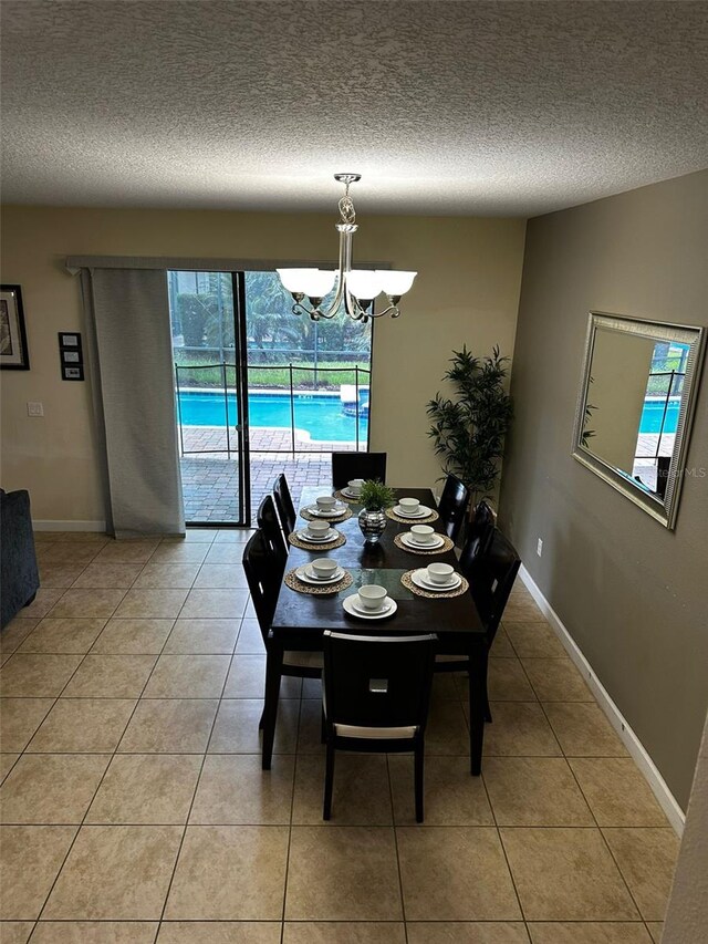 1439 Moon Valley Dr, Davenport, FL 33896 - dining space featuring a chandelier, a textured ceiling, and light tile patterned floors