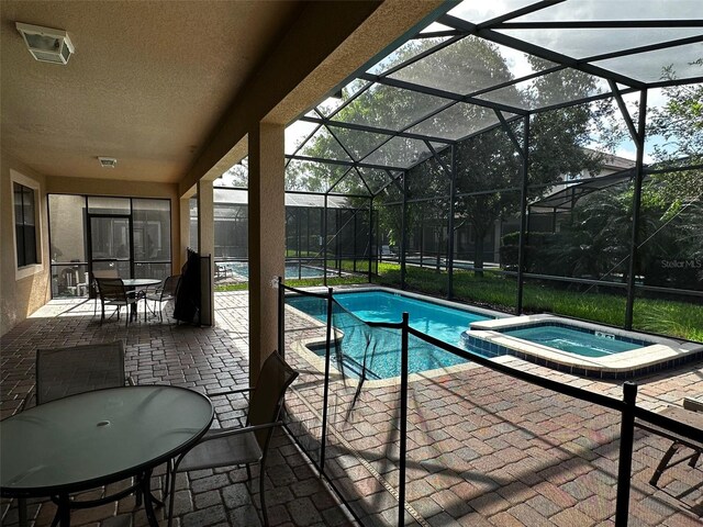 1439 Moon Valley Dr, Davenport, FL 33896 - view of pool with a patio, glass enclosure, and a pool with connected hot tub
