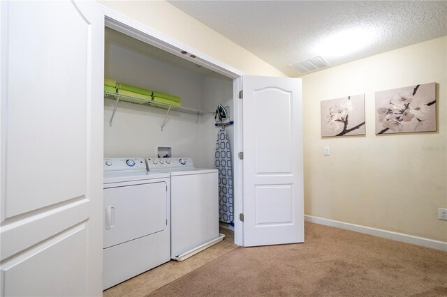 1439 Moon Valley Dr, Davenport, FL 33896 - laundry area with washer and clothes dryer, baseboards, a textured ceiling, and light carpet