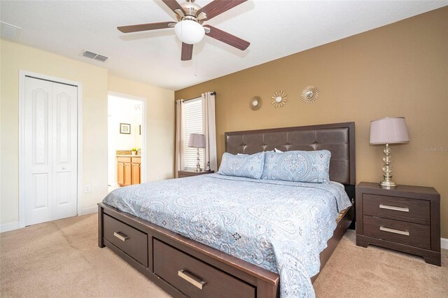 1439 Moon Valley Dr, Davenport, FL 33896 - bedroom with light colored carpet, a ceiling fan, a closet, and ensuite bathroom