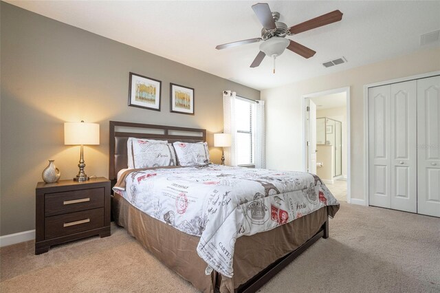 1439 Moon Valley Dr, Davenport, FL 33896 - bedroom with light colored carpet, a closet, connected bathroom, baseboards, and ceiling fan