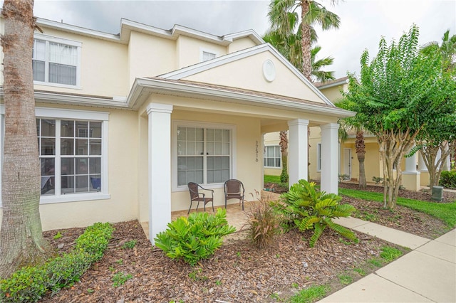 17516 Blessing Dr, Clermont, FL 34714 - view of front of house featuring stucco siding and a porch