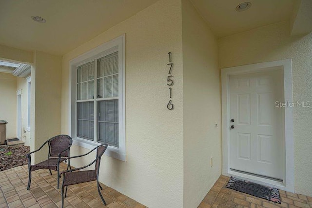 17516 Blessing Dr, Clermont, FL 34714 - entrance to property featuring stucco siding and covered porch