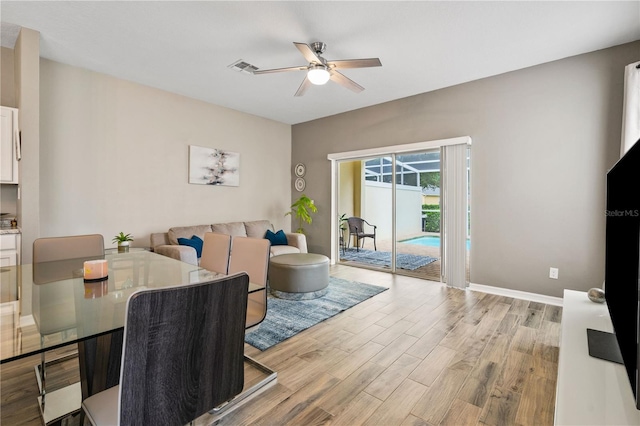 17516 Blessing Dr, Clermont, FL 34714 - living room with a ceiling fan, light wood finished floors, and baseboards