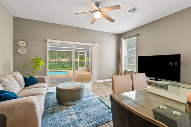 17516 Blessing Dr, Clermont, FL 34714 - living area with ceiling fan, wood finished floors, and baseboards
