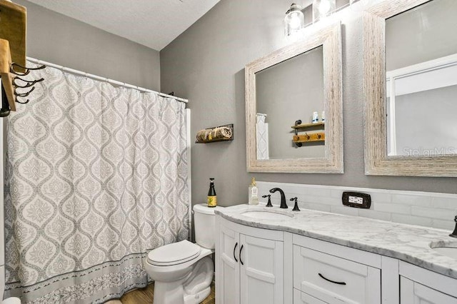 17516 Blessing Dr, Clermont, FL 34714 - bathroom featuring double vanity, toilet, wood finished floors, and a shower with shower curtain