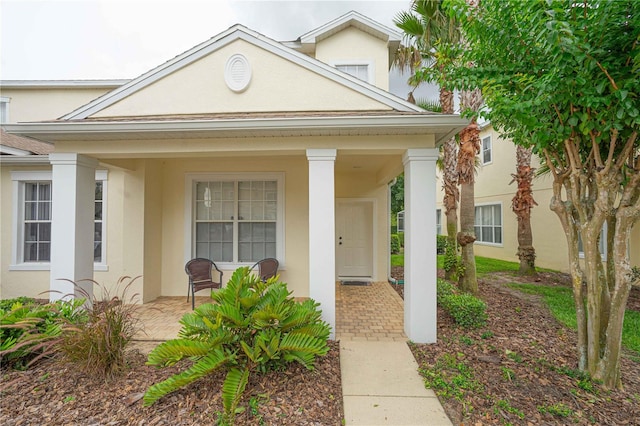 17516 Blessing Dr, Clermont, FL 34714 - property entrance featuring a porch and stucco siding