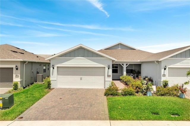 2578 Cliff Way, Saint Cloud, FL 34771 - single story home with board and batten siding, a garage, decorative driveway, a front lawn, and stucco siding
