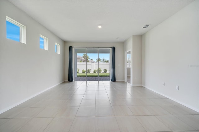 2578 Cliff Way, Saint Cloud, FL 34771 - empty room featuring plenty of natural light, baseboards, and light tile patterned flooring