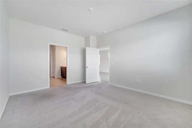 2578 Cliff Way, Saint Cloud, FL 34771 - unfurnished bedroom with light colored carpet, baseboards, and ensuite bathroom