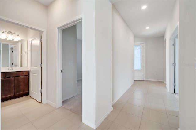 2578 Cliff Way, Saint Cloud, FL 34771 - hallway featuring baseboards, recessed lighting, light tile patterned floors, and a sink