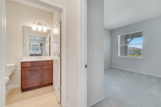2578 Cliff Way, Saint Cloud, FL 34771 - bathroom featuring toilet, vanity, baseboards, and a chandelier