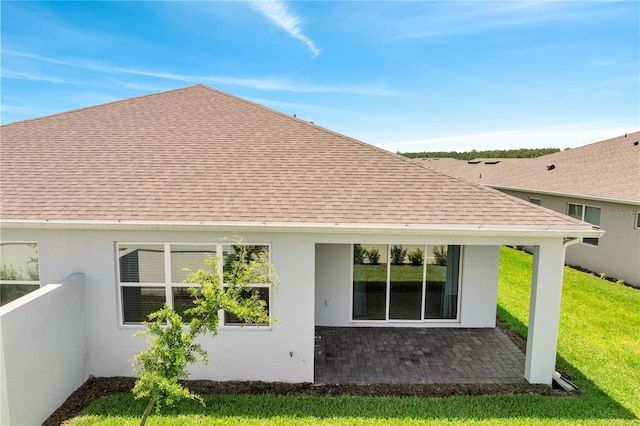 2578 Cliff Way, Saint Cloud, FL 34771 - back of house featuring roof with shingles, stucco siding, a yard, and a patio