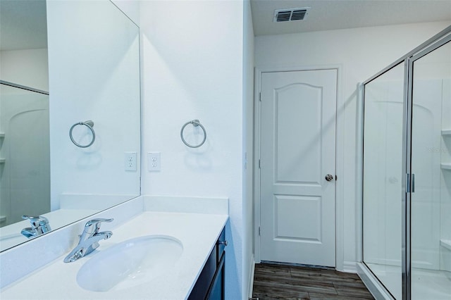 1303 Congo Ct, Kissimmee, FL 34759 - bathroom featuring vanity, a shower stall, and wood finished floors